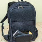 There is a wallet-sized zippered compartment with an elastic mesh sleeve at the base of the backpack that lines up conveniently with the small of the back. There is no chance of a pickpocket getting at it when the backpack is being worn.
